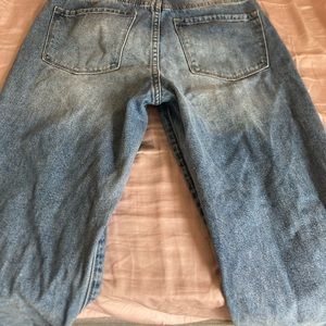 Blue baggy ripped jeans with 4 buttons.